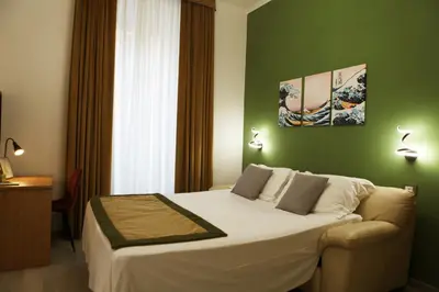 a hotel room with a bed and a couch at Vatican Museum Scipioni BED & Breakfast in Rome