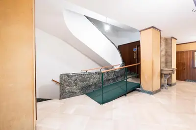 a hallway with a staircase in a building at Take It Easy Roma Guest House in Rome