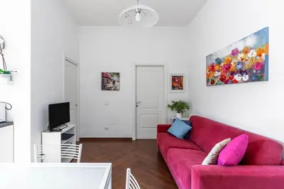 a living room with a red couch and a tv at Apartment Vatican Walls in Rome