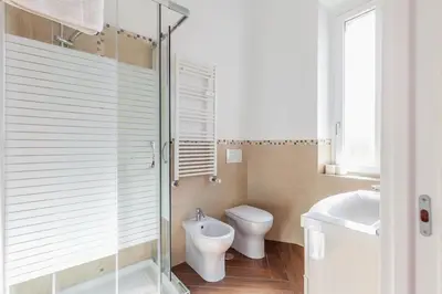 a bathroom with a toilet and a sink at Apartment Vatican Walls in Rome
