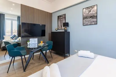 a living room with a bed and a dining room at Hostly-ColorHome Rome Midtown in Rome