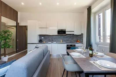 a kitchen and living room with a table and chairs at Hostly-ColorHome Rome Midtown in Rome