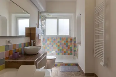 a bathroom with a sink and a toilet and a shower at GuestHost - 4 Winds Holiday Rental in Rome