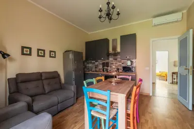 a kitchen and living room with a table and chairs at GuestHost - 4 Winds Holiday Rental in Rome