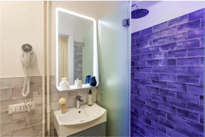 a bathroom with a sink and a mirror at Romi Suite in Rome