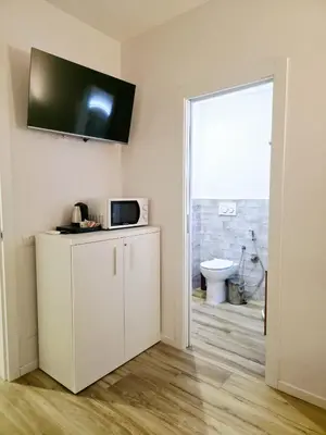 a room with a white cabinet with a microwave at Romi Suite in Rome