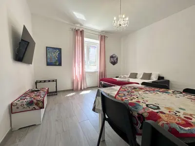 a living room with a bed and a couch at Appartamento per 4 persone a Garbatella - My Garba in Rome