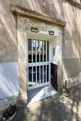 a door with a gate in the side of a building at Appartamento per 4 persone a Garbatella - My Garba in Rome
