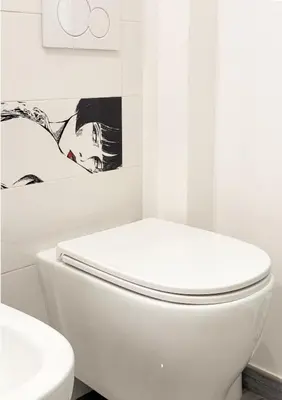 a white bathroom with a toilet and a sink at Appartamento per 4 persone a Garbatella - My Garba in Rome