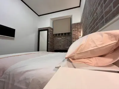a bedroom with a large bed with pink pillows at Casina Dacia in Rome