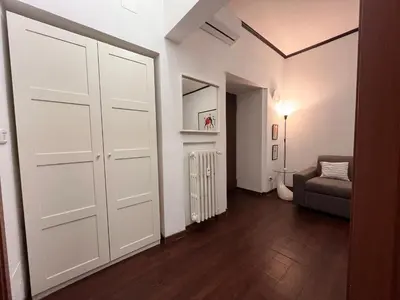 a room with a white door and a couch at Casina Dacia in Rome