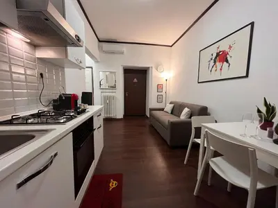 a kitchen and living room with a stove and a table at Casina Dacia in Rome
