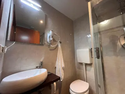 a bathroom with a sink and a toilet and a shower at Casina Dacia in Rome