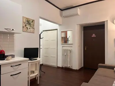 a living room with a couch and a tv in it at Casina Dacia in Rome