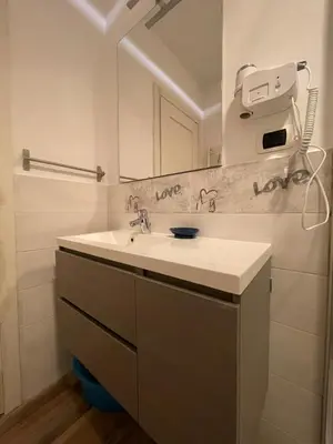 a bathroom with a sink and a mirror at La Stamperia in Rome