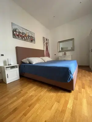a bedroom with a bed and a wooden floor at La Stamperia in Rome