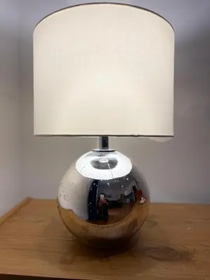 a lamp sitting on top of a wooden table at La Stamperia in Rome