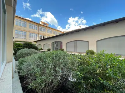 a building with windows and bushes in front of it at La Stamperia in Rome