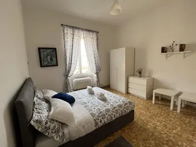 a bedroom with a bed and a window at interno 18 penthouse in Rome