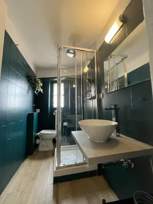 a bathroom with a sink and a glass shower at interno 18 penthouse in Rome