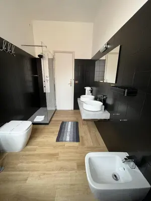 a bathroom with three sinks and two toilets at interno 18 penthouse in Rome