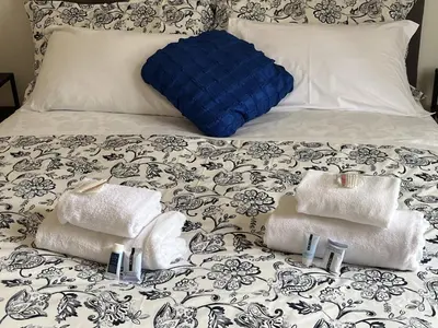 a bed with towels and pillows on it at interno 18 penthouse in Rome