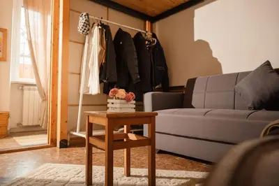a living room with a couch and a table at TWO-ROOM Apt. under the Aqueduct's ARCH in Pigneto in Rome
