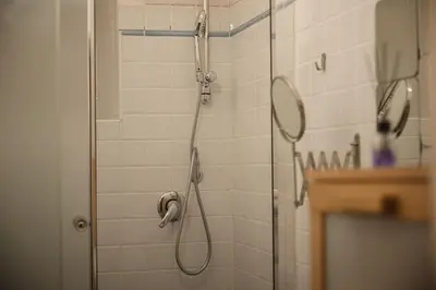 a shower in a bathroom with a mirror at TWO-ROOM Apt. under the Aqueduct's ARCH in Pigneto in Rome