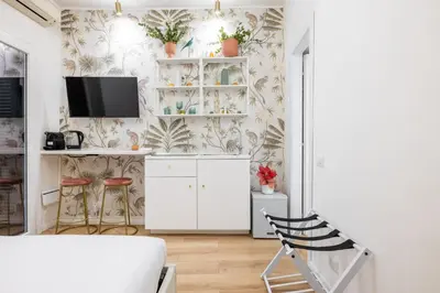 a living room with a tv on a wall at Leonina Apt - Colosseum in Rome