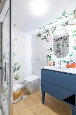 a bathroom with a blue sink and a mirror at Leonina Apt - Colosseum in Rome