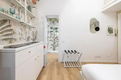 a kitchen with white cabinets and a sink at Leonina Apt - Colosseum in Rome