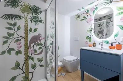 a bathroom with a shower with a monkey on the wall at Leonina Apt - Colosseum in Rome