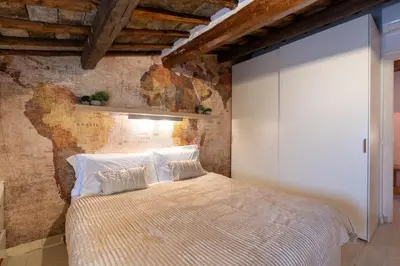 a bedroom with a large bed with a glass wall at [15 min from Piazza Venezia] Skyline Sanctuary in Trastevere in Rome