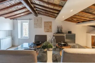 a living room with a table and a window at [15 min from Piazza Venezia] Skyline Sanctuary in Trastevere in Rome