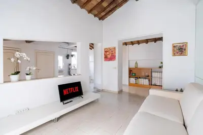 a bedroom with a bed in a room with white walls at [15 min from Piazza Venezia] Skyline Sanctuary in Trastevere in Rome