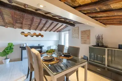 a bedroom with a large bed and a couch at [15 min from Piazza Venezia] Skyline Sanctuary in Trastevere in Rome