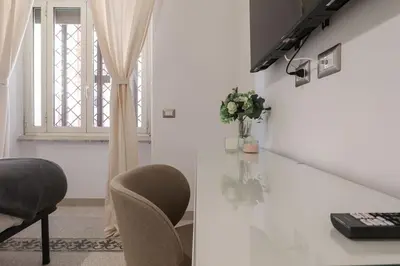 a room with a table and a chair and a window at Vaticano - appartamento nuovo in Rome