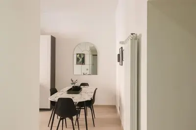 a dining room with a table and black chairs at Vaticano - appartamento nuovo in Rome
