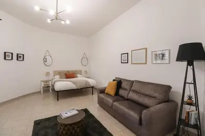 a living room with a couch and a bed at Vaticano - appartamento nuovo in Rome