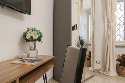a dining room table with a vase of flowers on it at Vaticano - appartamento nuovo in Rome