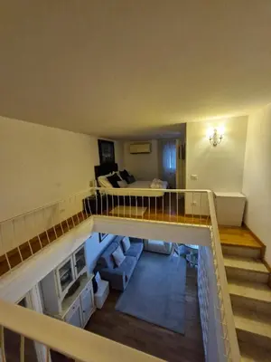 a room with a staircase and a living room at Apartment luxury Archimede 80 in Rome