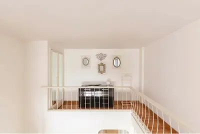 a white room with a staircase with white walls at Apartment luxury Archimede 80 in Rome
