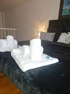a pile of towels sitting on top of a bed at Apartment luxury Archimede 80 in Rome