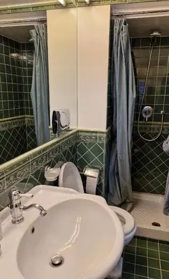 a bathroom with a sink and a toilet and a mirror at Apartment luxury Archimede 80 in Rome