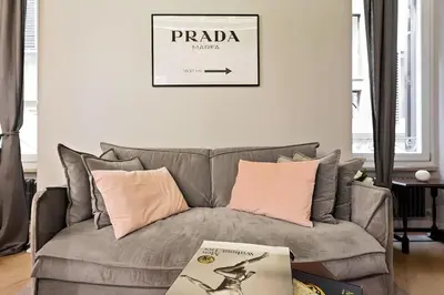 a living room with a gray couch with pink pillows at HostMe Piazza Navona Apartament in Rome