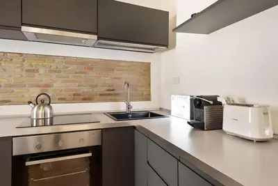 a kitchen with a sink and a microwave at HostMe Piazza Navona Apartament in Rome