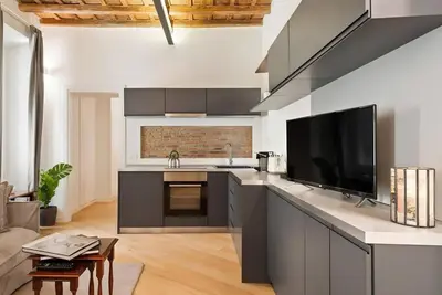 a kitchen with a sink and a tv on a counter at HostMe Piazza Navona Apartament in Rome
