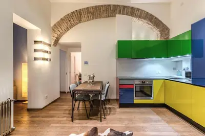 a kitchen with a table and a dining room at Domus Mondrian Luxury House in Rome