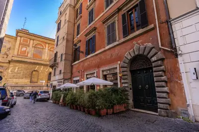 a building with umbrellas on the side of a street at Domus Mondrian Luxury House in Rome