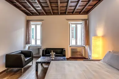 a living room with a bed and a table and chairs at Domus Mondrian Luxury House in Rome